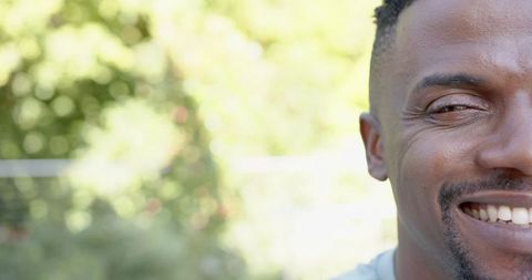 Close-Up of Smiling Man Outdoors in Sunlight