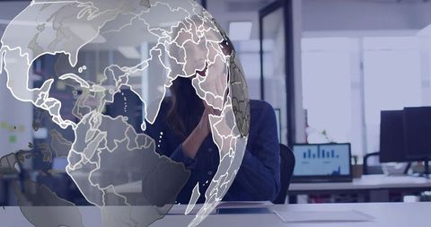Contemplating businesswoman analyzing global strategy at modern office with globe overlay