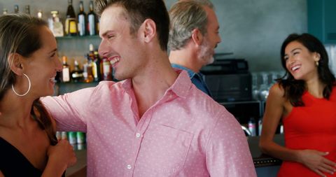 Young couples socializing at trendy bar atmosphere
