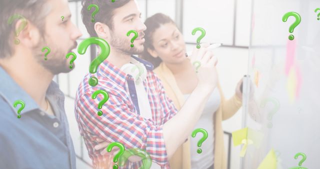 Image of green question marks over business people looking at memo notes. business, finance and office workplace concept digitally generated image.