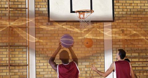 Youthful basketball teams training in gymnasium