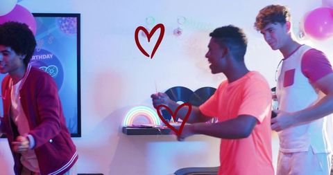 Laughing Friends Celebrating with Sparklers Beside Neon Rainbow Lamp and Vinyl Records