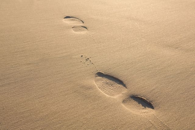 Close up of footprints on sand at beach