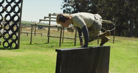 Female soldier practicing obstacle training outdoors