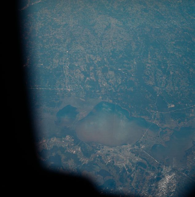 The greater New Orleans area, including portions of Louisiana and Mississippi, as seen from the Apollo 7 spacecraft during its 120th revolution of the earth. Photographed from an altitude of 95 nautical miles, at ground elapsed time of 190 hours and 45 minutes. The largest body of water in the picture is Lake Pontchartrain. The Mississippi River is clearly visible as it meanders past New Orleans. Note highway network, and 25-mile causeway across lake.