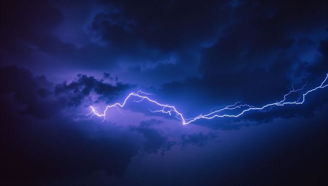 Dramatic lightning bolt piercing stormy night sky