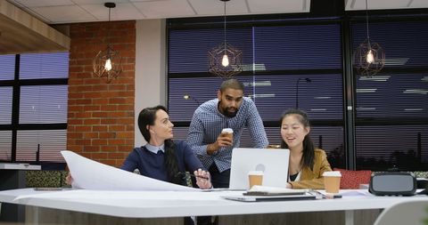 Team Collaboration in Modern Office at Dusk