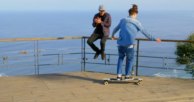 Two Young Men Skateboarding by Scenic Ocean View - Download Free Stock Images Pikwizard.com