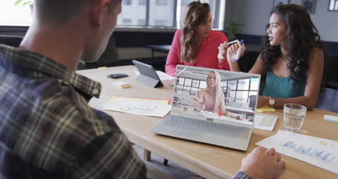 Diverse Team in Office Having Video Meeting on Laptop
