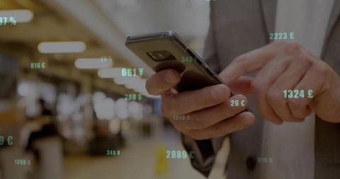 Businessman Engaging with Currency Rates on Smartphone in Modern Lobby