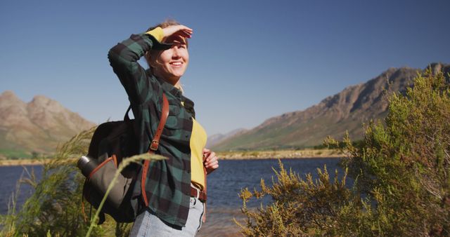 Adventurous Woman Hiking Near Serene Lake with Mountain Views - Download Free Stock Images Pikwizard.com