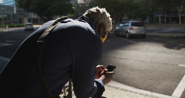 Man on Urban Street Using Smartphone in Sunlight - Download Free Stock Images Pikwizard.com