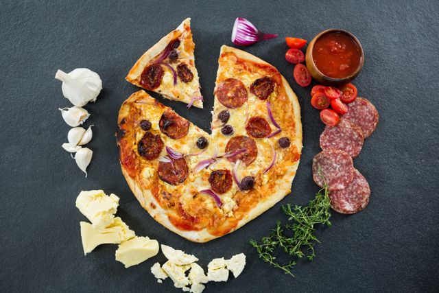 Overhead view of italian pizza with various ingredients and salami