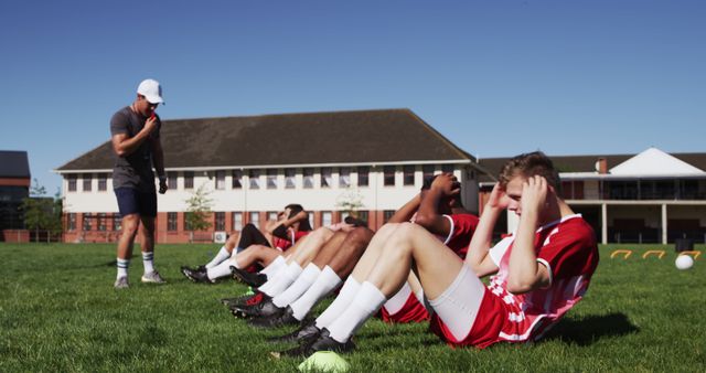 Soccer Team Performing Sit-Ups During Training Session on Field - Download Free Stock Images Pikwizard.com