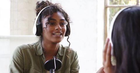 African american podcasters hosting talk show in professional studio