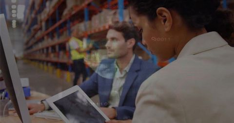 Hispanic operations manager checking tablet in warehouse while team coordinating logistics