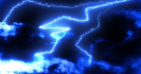 Bright blue lightning bolts in dark night sky