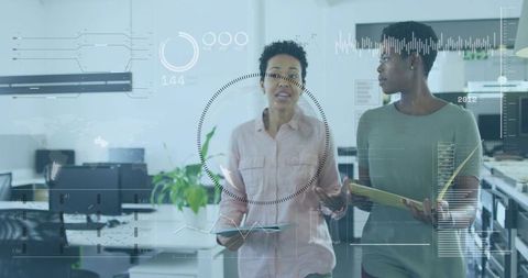 Collaborating colleagues walking through modern open-plan office with data HUD overlays