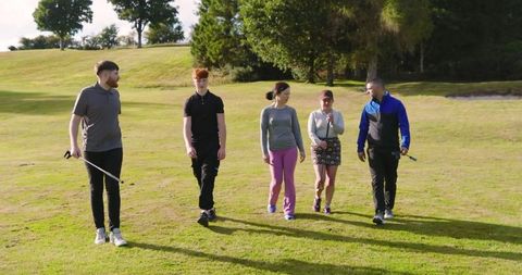 Friends Strolling Golf Course Fairway in Casual Golf Attire