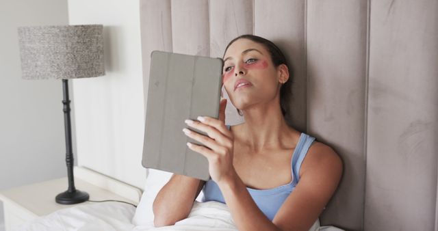 Woman in Bed with Bruised Face Using Digital Tablet - Download Free Stock Images Pikwizard.com