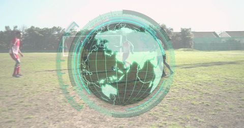 Youth soccer players running across grass field with holographic globe overlay and ball