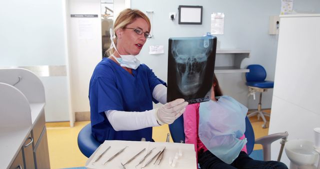 Dentist Reviewing X-Ray with Child Patient in Clinic - Download Free Stock Images Pikwizard.com