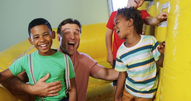 Happy Group of Diverse Kids and Adult Laughing and Playing on Inflatable Bouncer - Download Free Stock Images Pikwizard.com