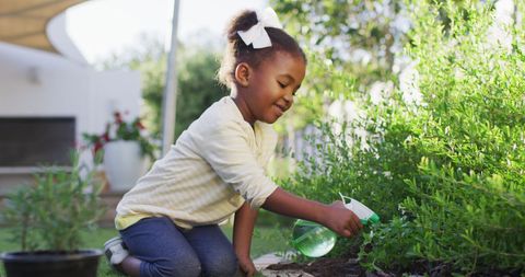 Joyful Child Watering Plants in Lush Home Garden