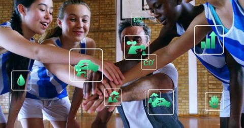 Youth basketball team huddling with coach showing green sustainability and analytics icons