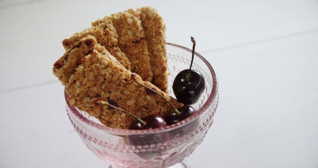 Granola Bars and Fresh Cherries in Elegant Pink Glass Bowl - Download Free Stock Images Pikwizard.com