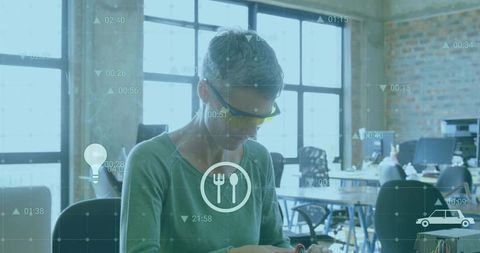 Technician analyzing electronic parts with futuristic data overlays