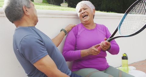 Joyful Senior Couple Enjoying Tennis Together