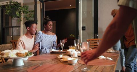 Friends Enjoying Festive Dinner Party in Cozy Home Setting