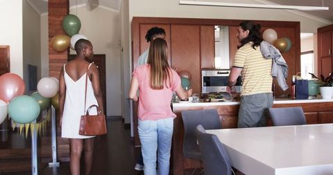 Friends Gathering in Modern Kitchen for Celebration Event