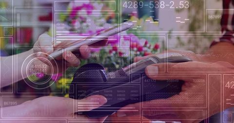Hands using smartphone for contactless payment in flower shop