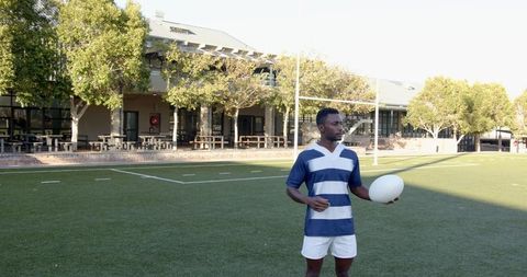 Rugby player standing proudly on sports field