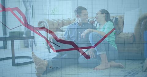 Couple analyzing business data with overlay chart at home