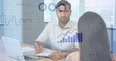 Diverse Business Team Analyzing Financial Data Trends in Modern Office