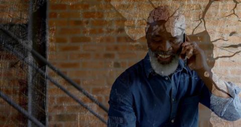 Stylish Senior Man Conversing on Smartphone in Industrial Loft