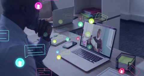 Businessman engaging in virtual meeting with chat icons overlay