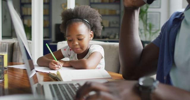 Young African American Girl Doing Homework at Home with Digital Learning Tools - Download Free Stock Images Pikwizard.com