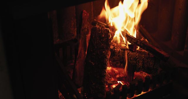 Close up of logs burning in a fireplace in the sitting room of a home. Cozy Christmas Atmosphere with warm light. 4k