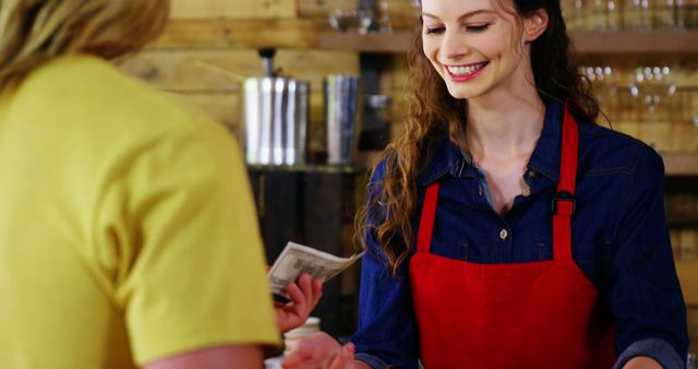 Friendly Barista Serving Customer with a Smile in Coffee Shop - Download Free Stock Images Pikwizard.com