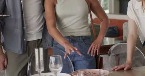 Couple discussing wedding plans at home with friends