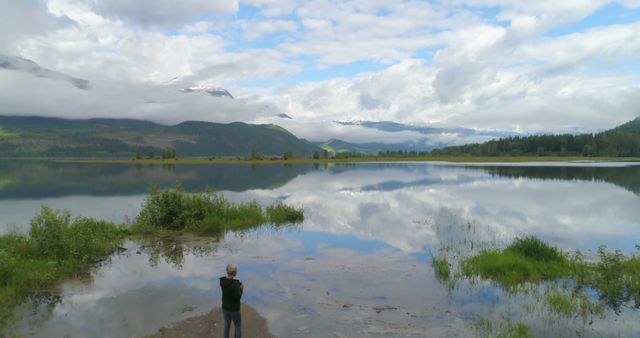 Young Boy Enjoying Scenic Lake Landscape with Mountain Reflections - Download Free Stock Photos Pikwizard.com