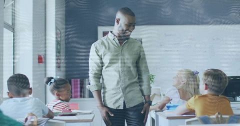 Male Teacher Engaging Elementary Students in Bright Classroom, Collaborative Learning