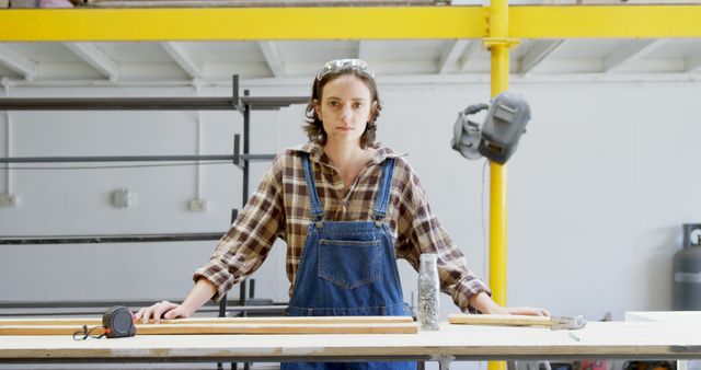 Female Woodworker in Overalls Stands at Workbench in Workshop - Download Free Stock Images Pikwizard.com