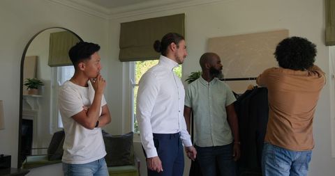 Friends Assisting Groom with Wedding Preparations at Home