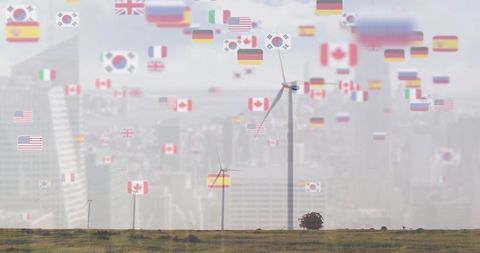 Wind turbines against multiple national flags symbolizing global cooperation