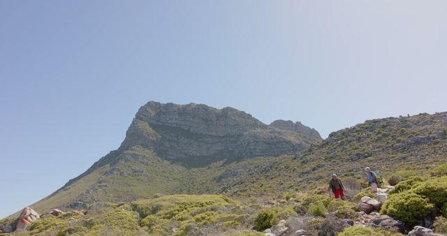 Hikers Climbing Rugged Mountain Under Clear Sky - Download Free Stock Images Pikwizard.com